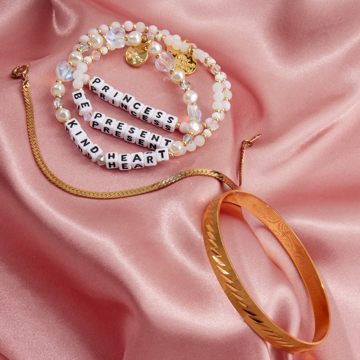 Set of bracelets on a pink satin background